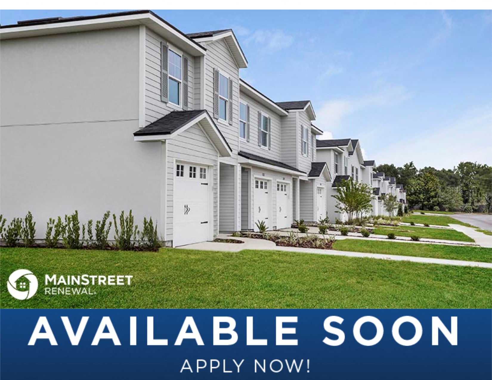 an image of a row of white houses with green grass
