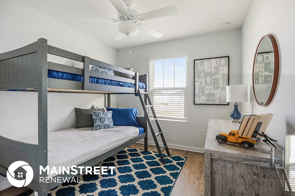 a bedroom with bunk beds and a ceiling fan
