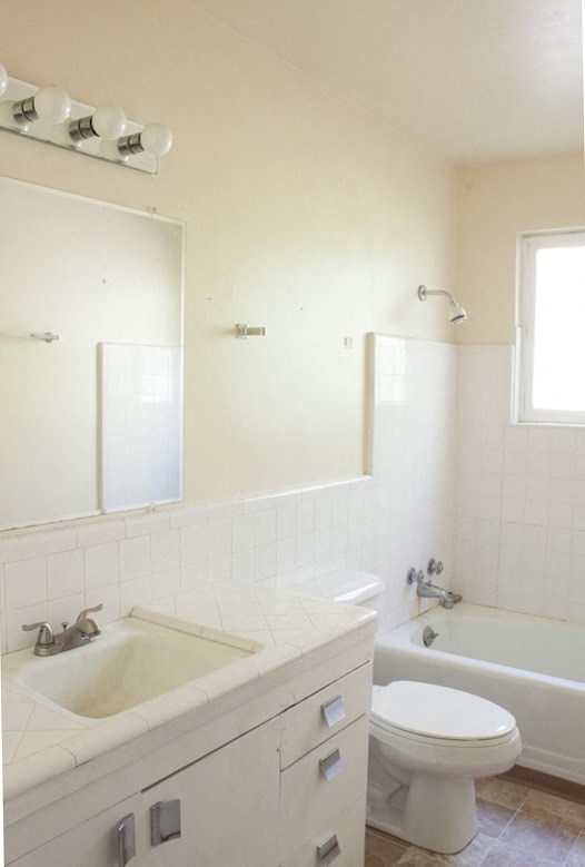 A white bathroom with a sink, toilet, and bathtub.
