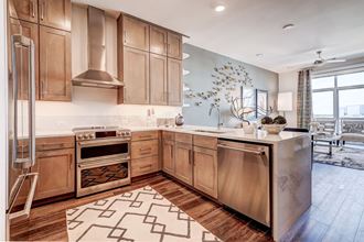 a kitchen with wooden cabinets and stainless steel appliances