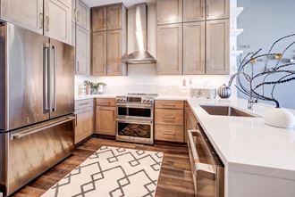 a kitchen with wooden cabinets and stainless steel appliances