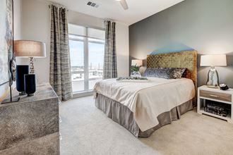a bedroom with a large bed and a window