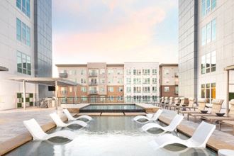 a swimming pool in the middle of tall buildings