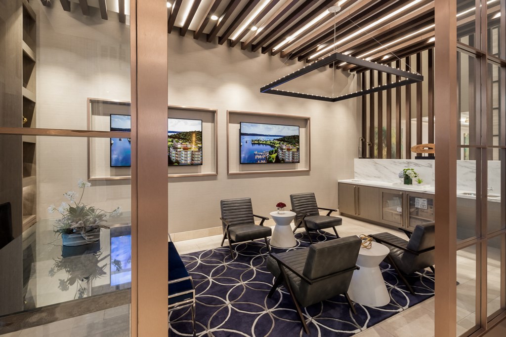 a living room with chairs and a table