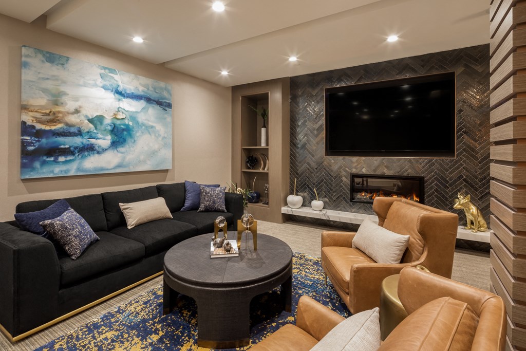 a living room with couches and a table and a television