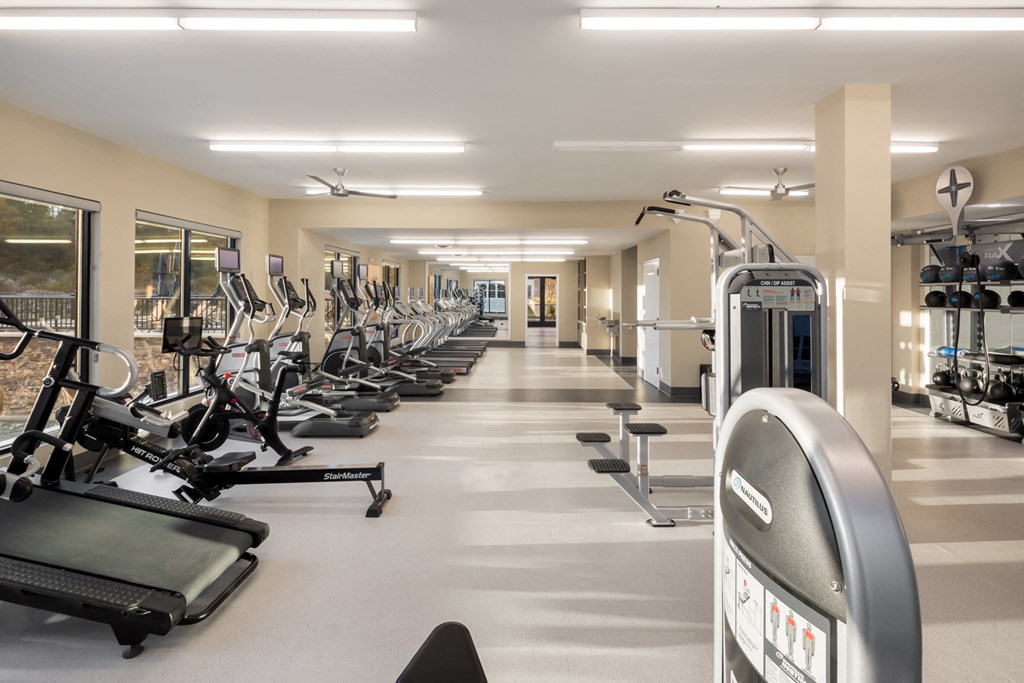 a fitness room filled with cardio machines and weights