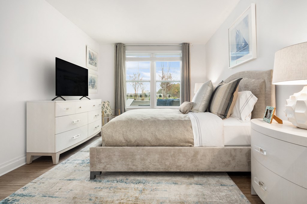 a bedroom with a large bed and a tv