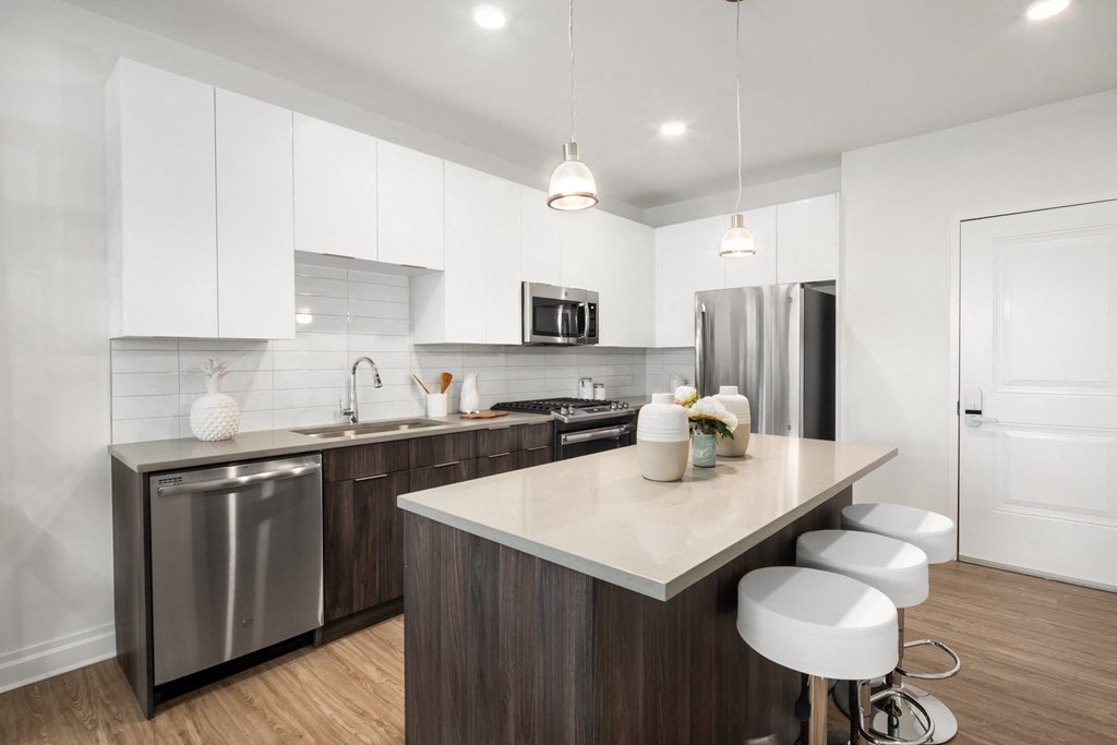 a kitchen with stainless steel appliances and an island with stools