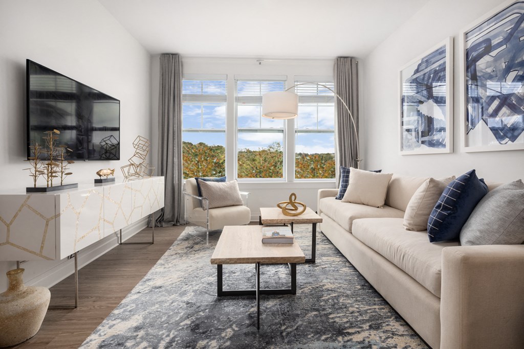 a living room with a white couch and a large window