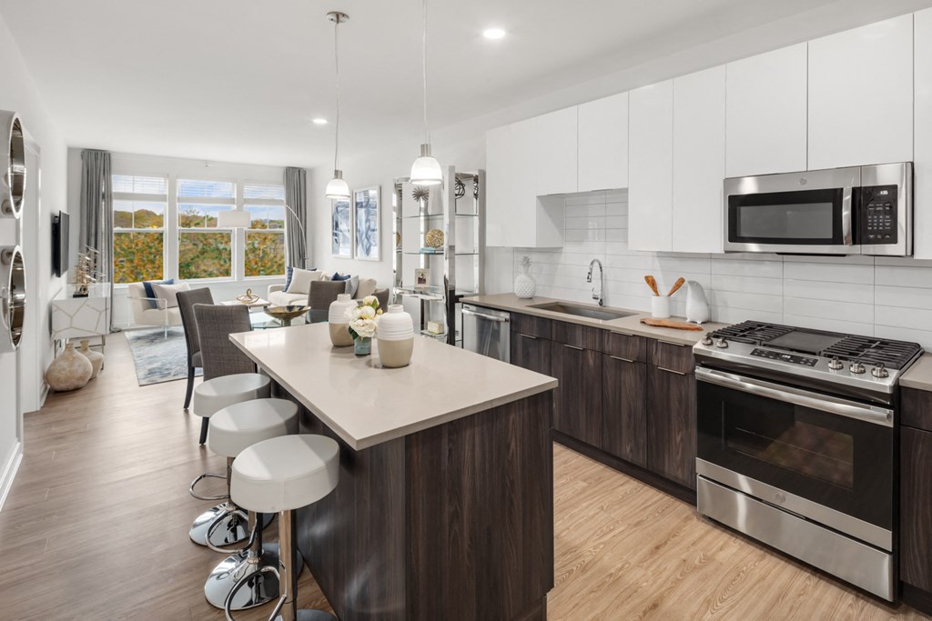 an open kitchen and living room with a table and chairs