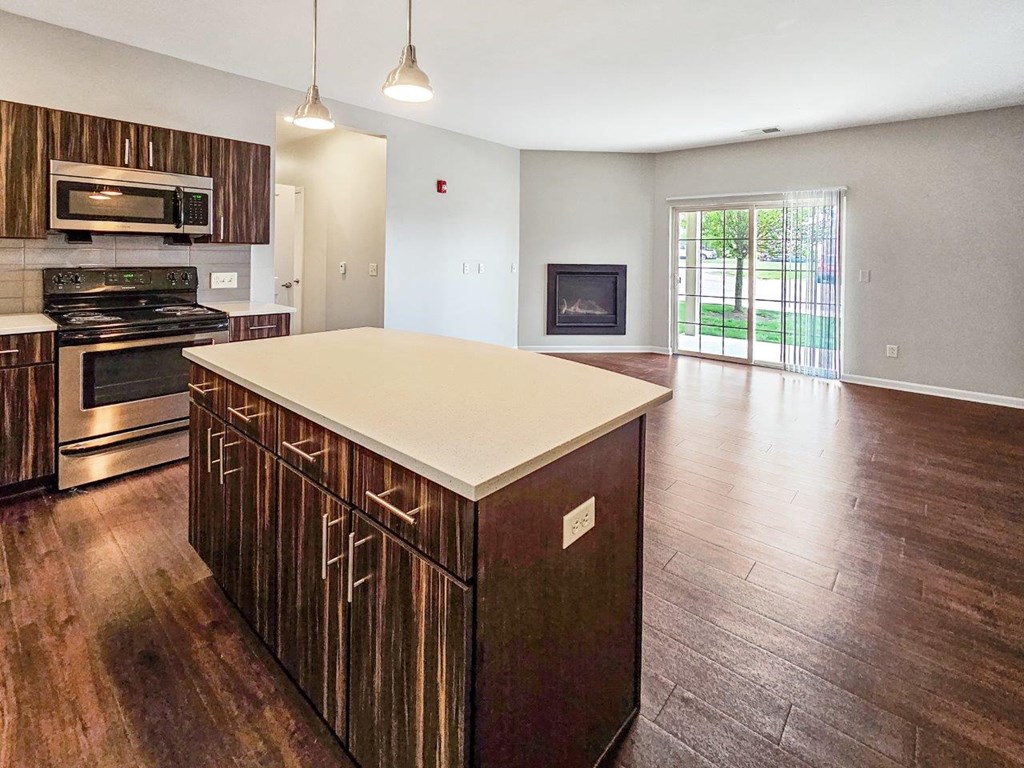 a large kitchen with a center island and a fireplace