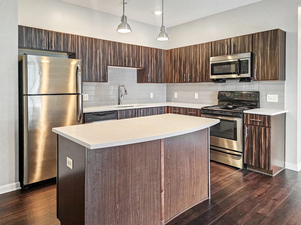 a kitchen with stainless steel appliances and a white counter top