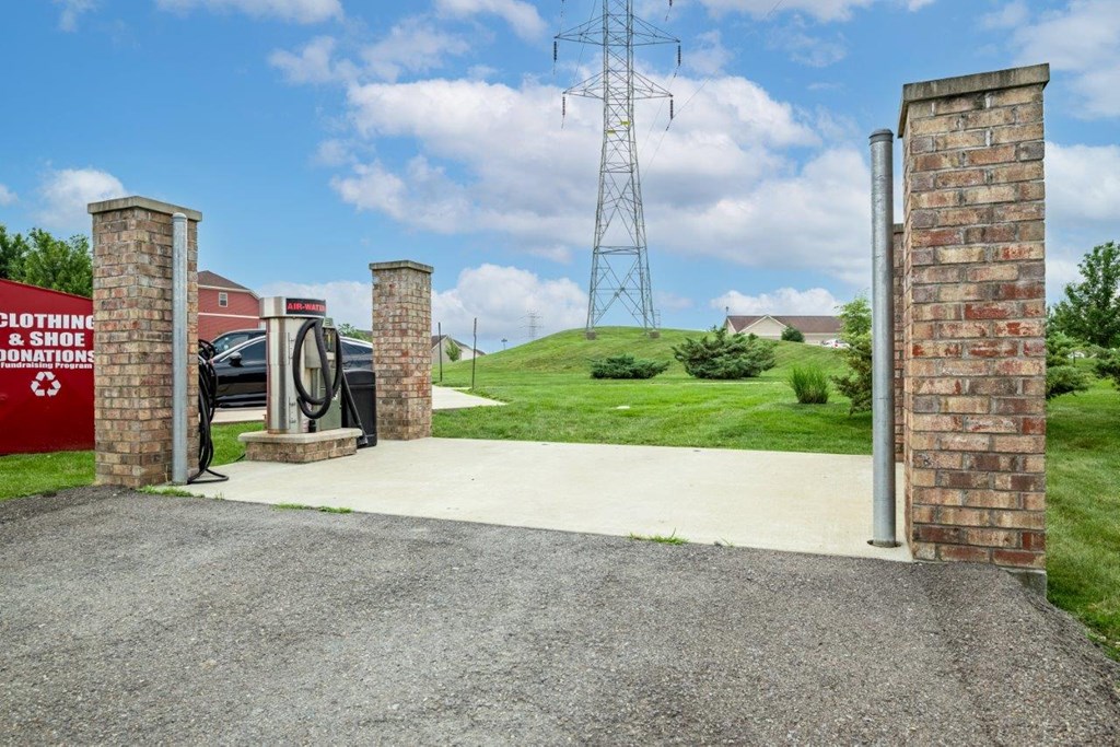 the entrance to a gas station with a gas pump