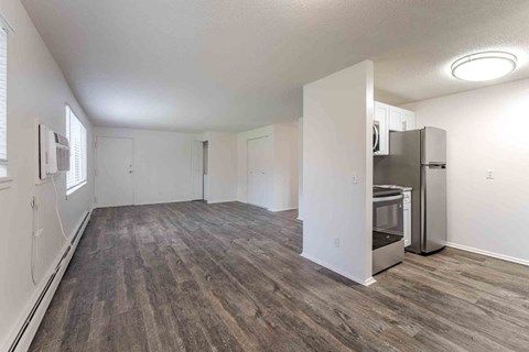 A kitchen area with a refrigerator and microwave.
