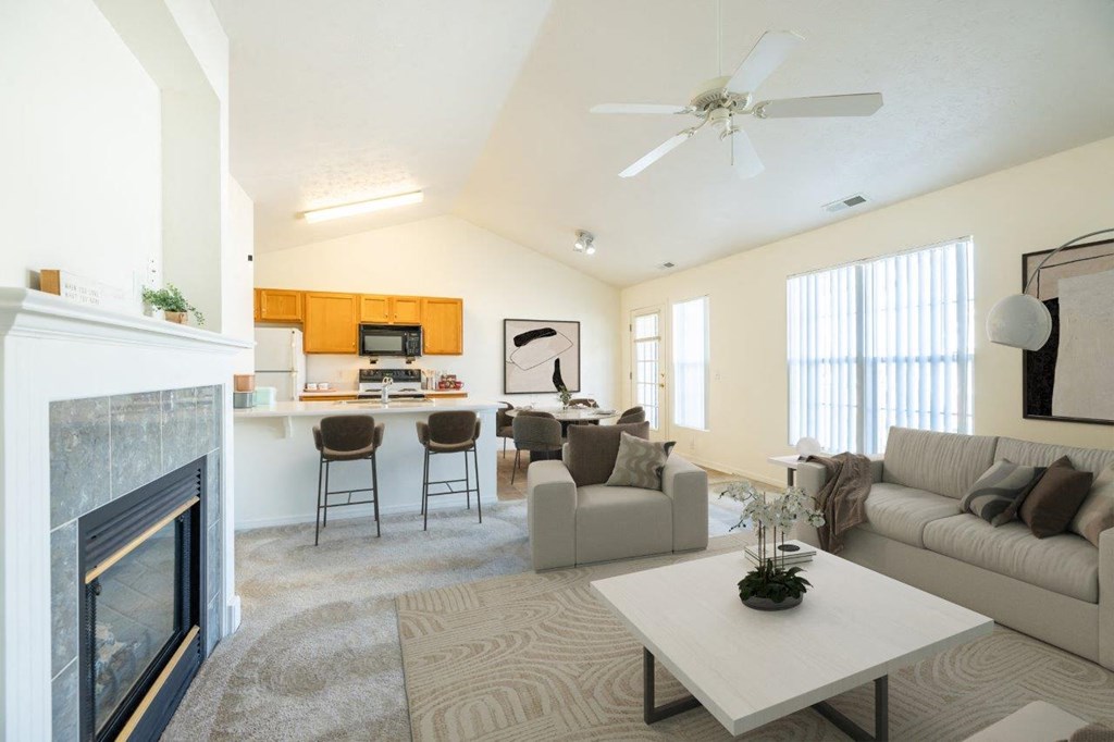 a living room with a fireplace and a couch and a table