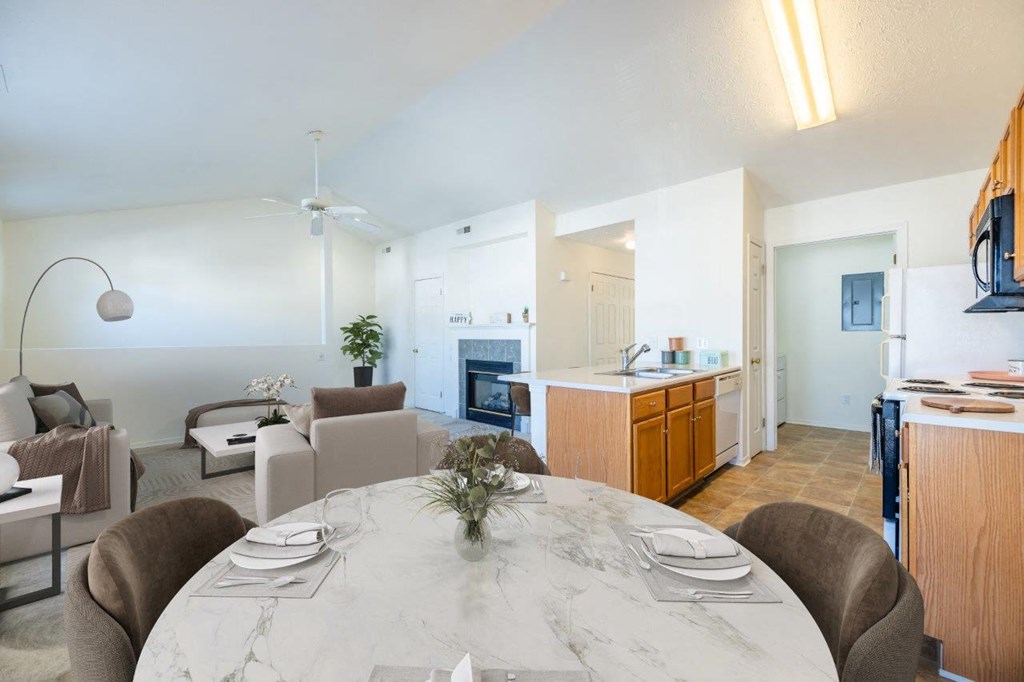 a dining room and living room with a marble table