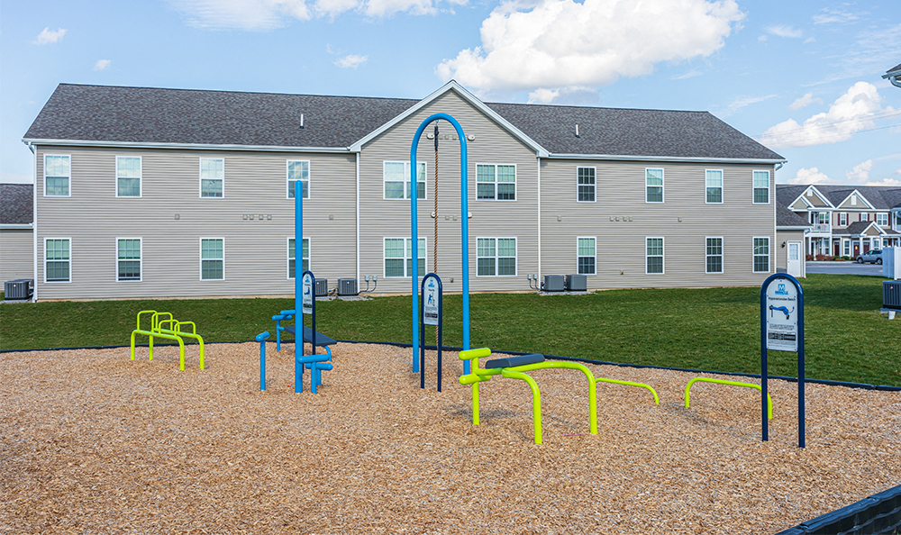 Outdoor fitness stations with signs instructing how to use each station