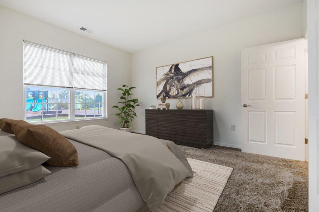 a bedroom with a large bed and a window