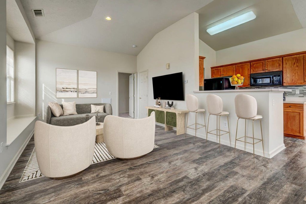 a living room and kitchen with a couch and a table