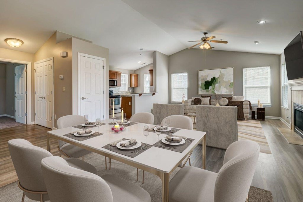 a dining room and living room with a table and chairs
