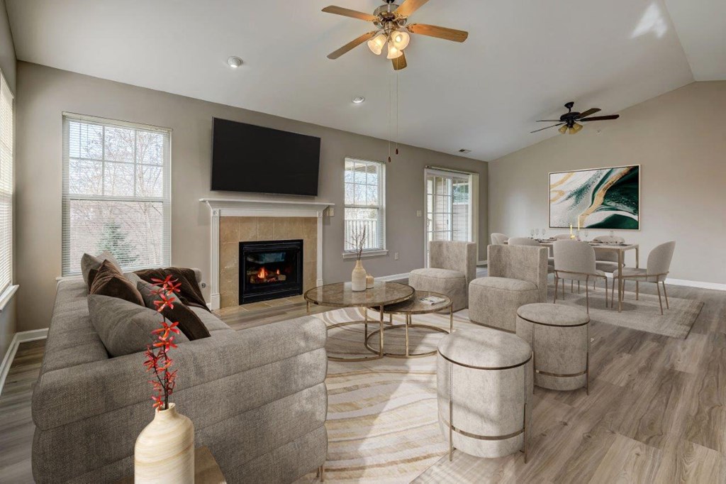 a living room with couches and chairs and a fireplace