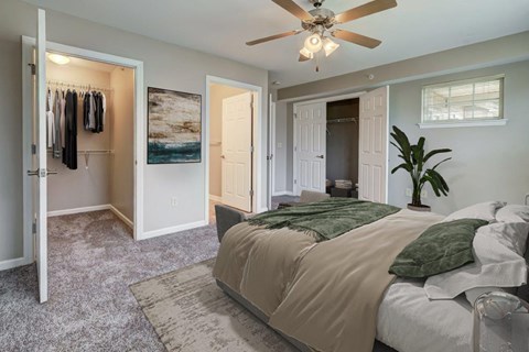 a bedroom with a bed and a ceiling fan