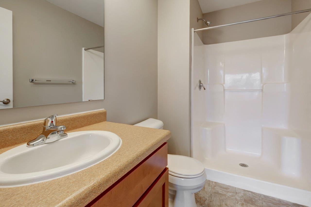 a bathroom with a sink toilet and a shower