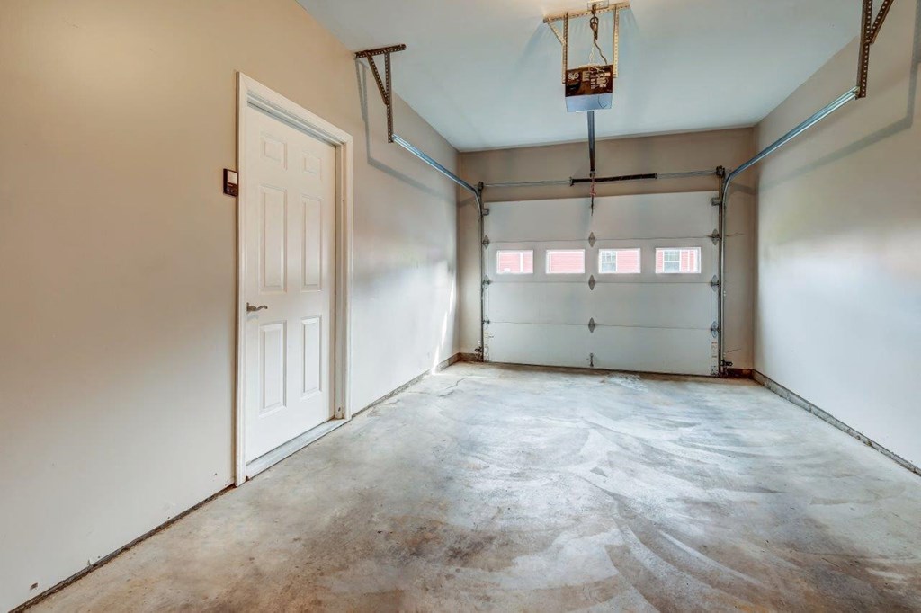 the inside of a garage with a white wall and a door