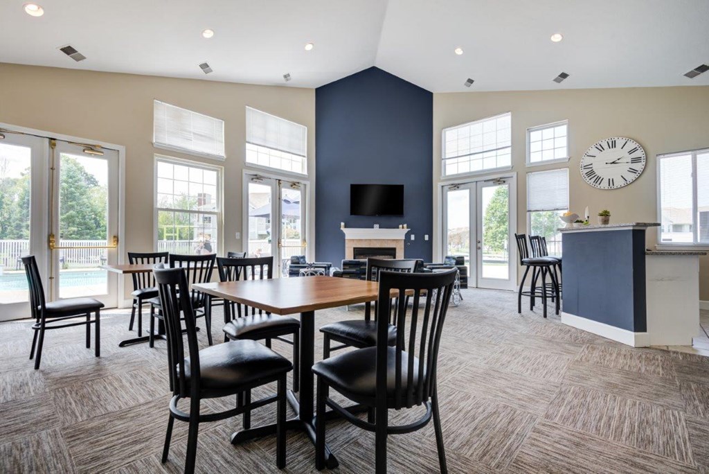 a conference room with a table and chairs and a clock on the wall