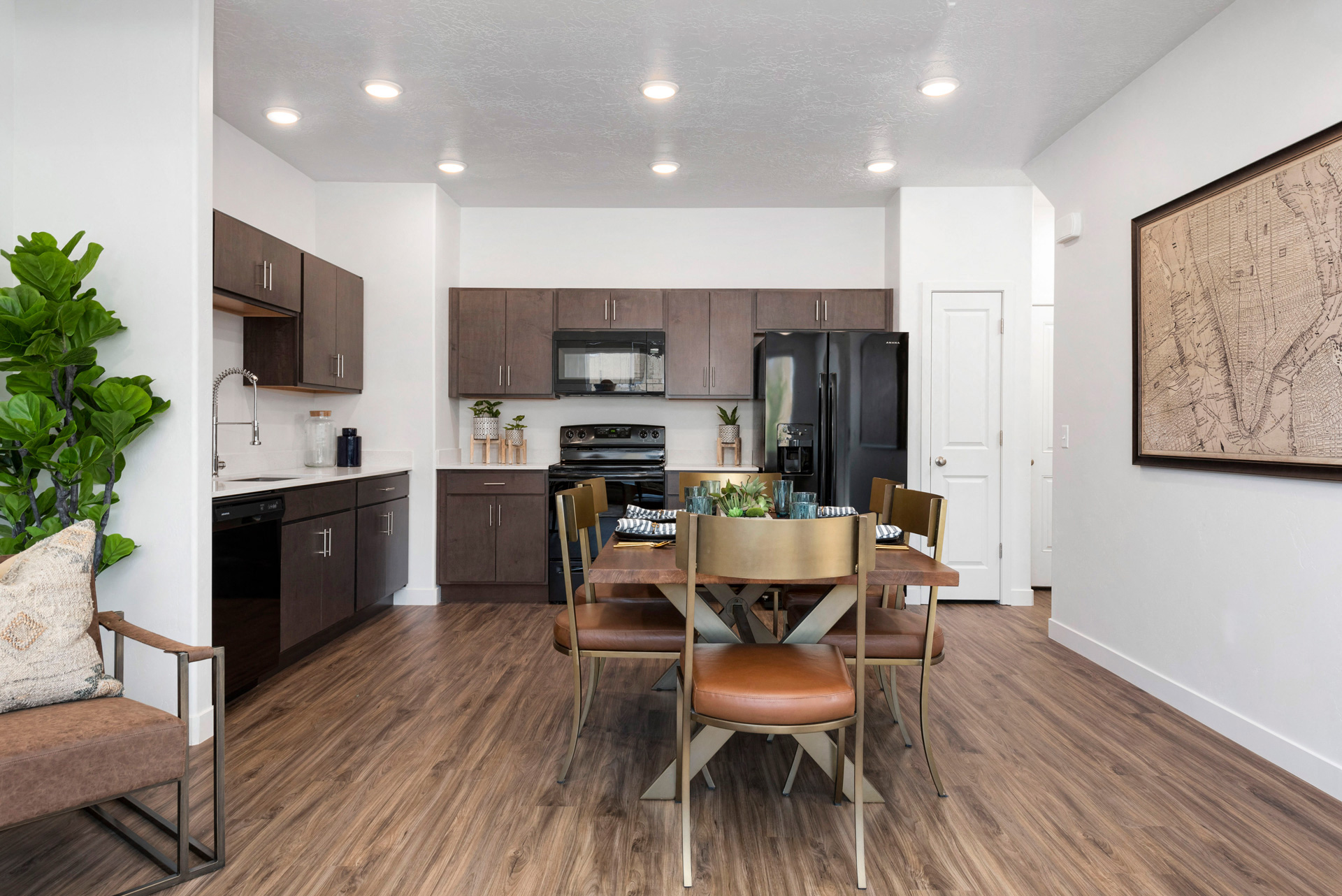 A modern kitchen with brown chairs and a wooden table.