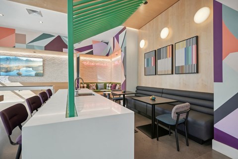 the interior of a restaurant with tables and couches