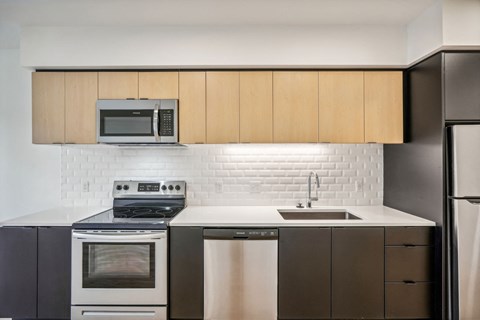 a kitchen with a sink and a stove and a microwave