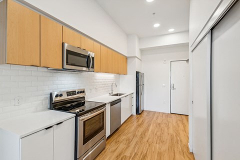 a kitchen with white appliances and wooden cabinets