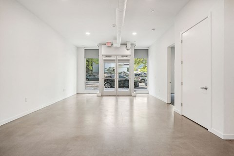a large empty room with white walls and white doors
