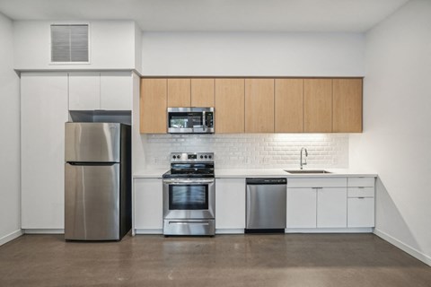 a kitchen with white cabinets and stainless steel appliances