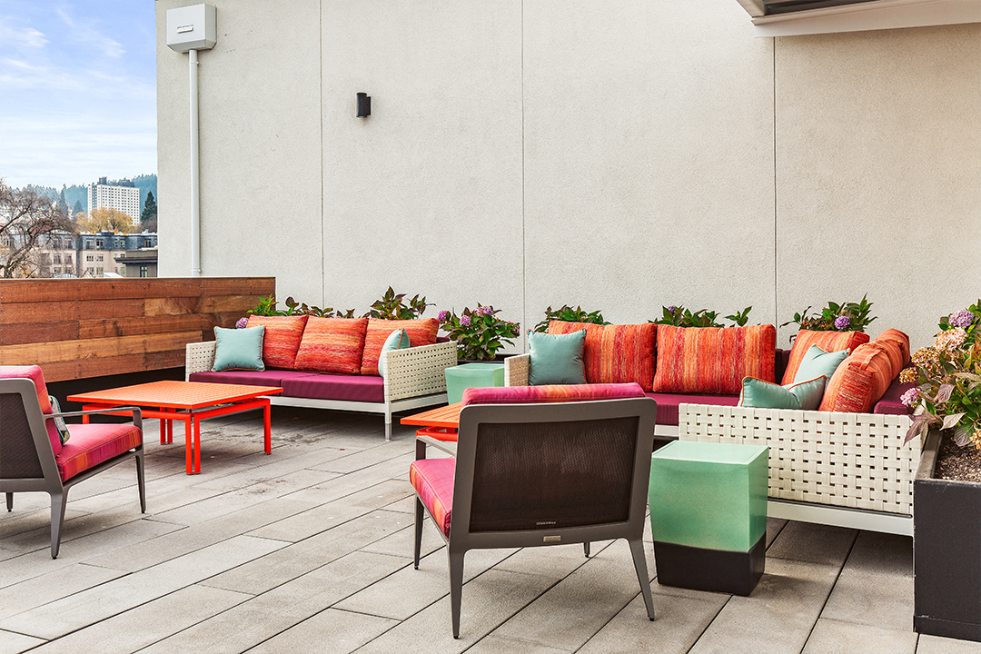 an outdoor patio with couches and tables and chairs