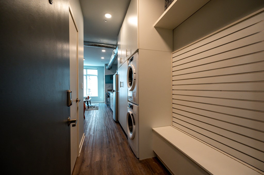 a laundry room with a washer and dryer and a door