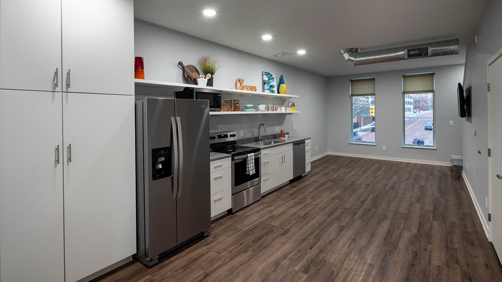 a kitchen with stainless steel appliances and white cabinets