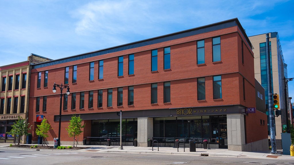 a red brick building on the corner of a city street