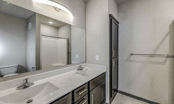 a bathroom with two sinks and a large mirror