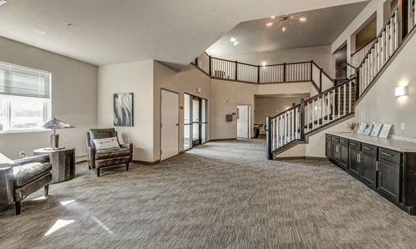 a large living room with a staircase and a dining room