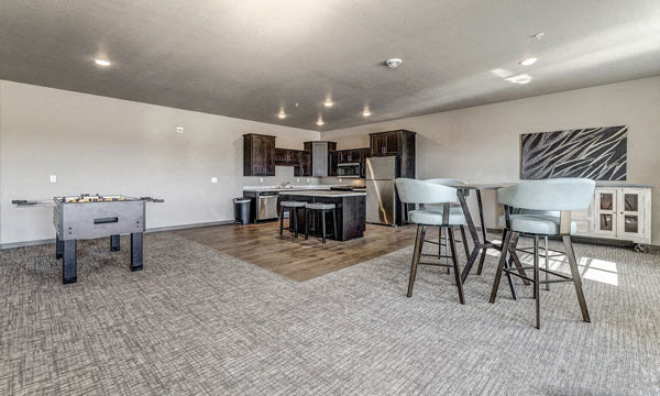 a living room with a bar and a table with chairs