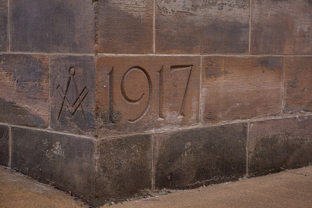a brick wall with the number 107 on it etched into it