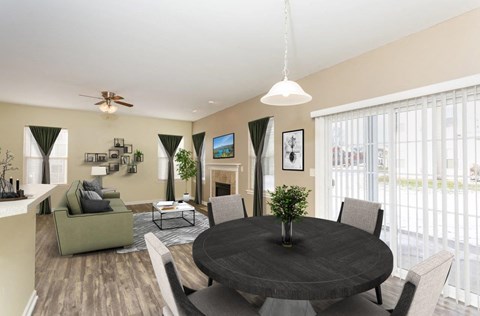 A living room with a grey table surrounded by grey chairs.