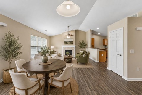 A dining room with a wooden table and chairs.