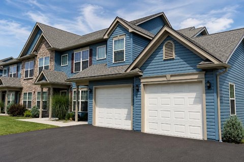 A blue house with a white garage door.