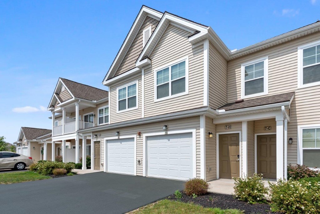 the front of a house with two garage doors