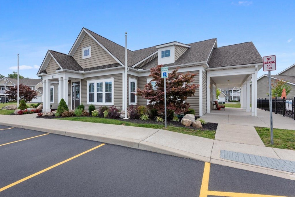 the front of a house with a driveway and a parking lot