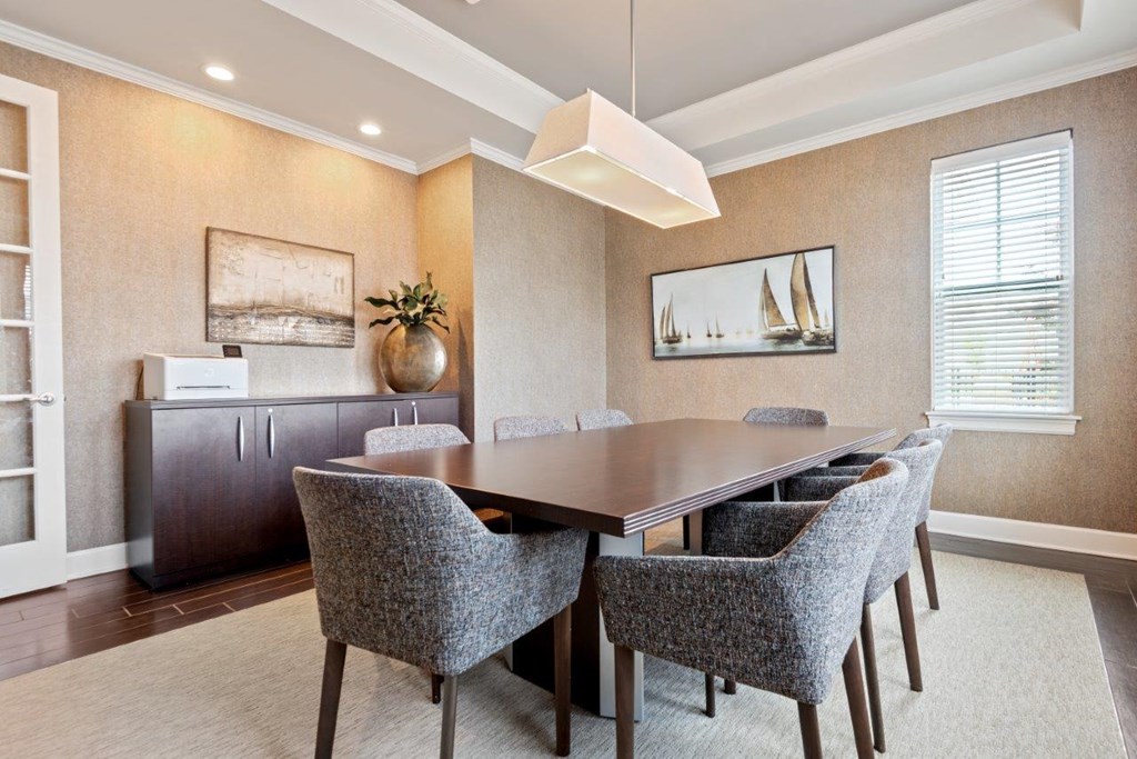 a dining room with a wooden table and chairs