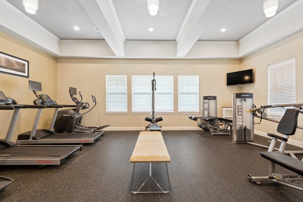 a gym with treadmills and other exercise equipment